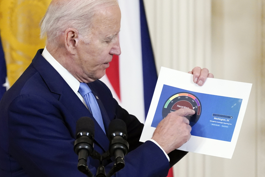 President Joe Biden holds a paper showing an air quality level for Washington as he speaks about Canada's wildfires during a news conference Thursday in the East Room of the White House in Washington.