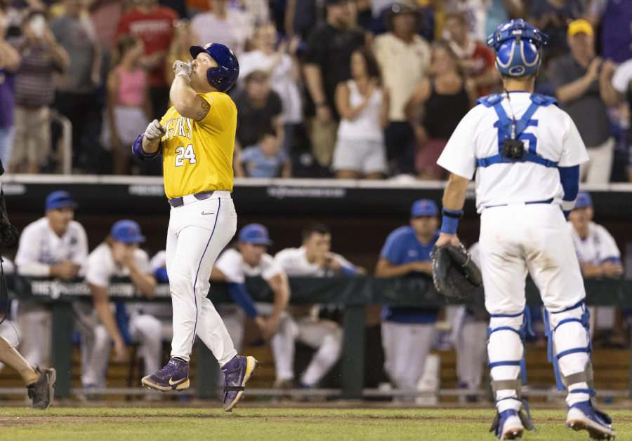 LSU's Cade Veloso (24) celebrates as he approaches home plate after hitting a solo home run to take the lead against Florida in the 11th inning of Game 1 of the NCAA College World Series baseball finals in Omaha, Neb., Saturday, June 24, 2023. (AP Photo/Rebecca S.