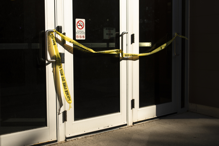 Police tape cordons off a door following a stabbing at the University of Waterloo, in Waterloo, Ontario, Wednesday, June 28, 2023. Waterloo Regional Police said three victims were stabbed inside the university's Hagey Hall, and a person was taken into custody.