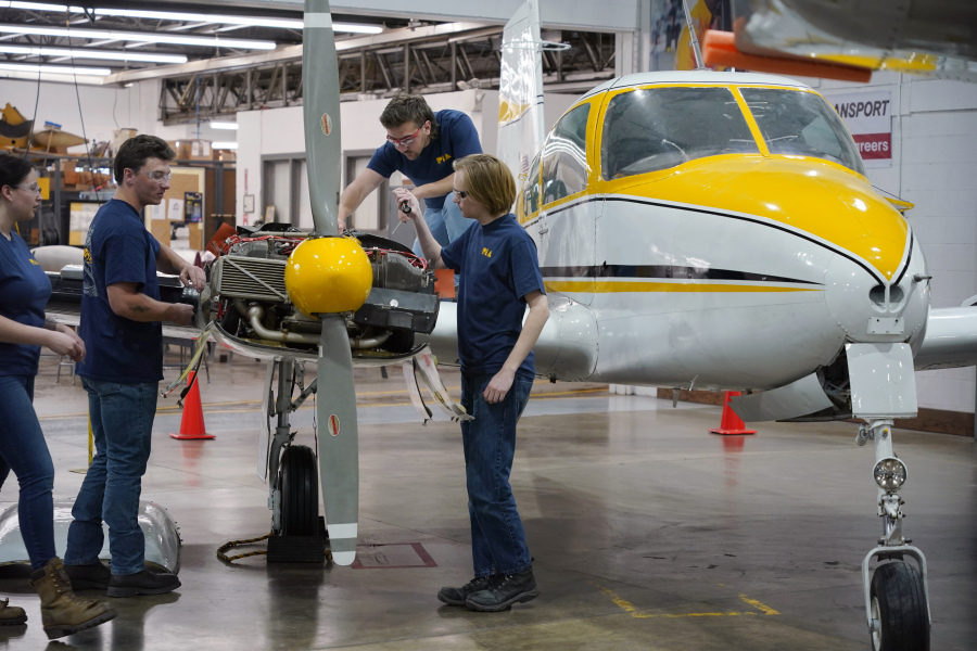 Students at the Pittsburgh Institute of Aeronautics study an engine May 2 on a Cessna 310 aircraft in West Mifflin, Pa. (Gene J.