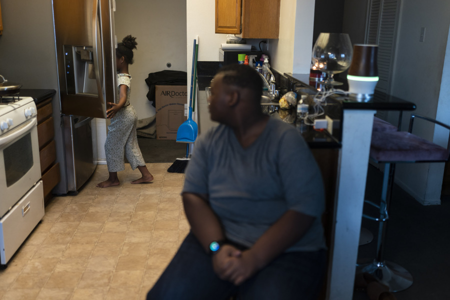 John Simon, a teenager who had bariatric surgery in 2022, watches as his sister, Haley, opens a refrigerator for food March 13 in their apartment in Los Angeles. (Jae C.