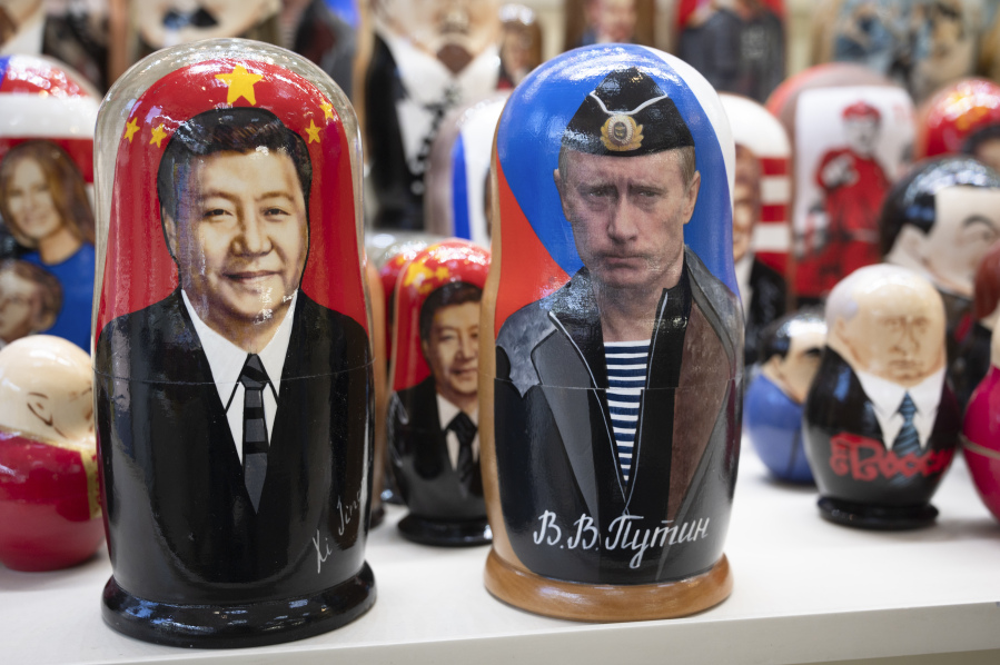 FILE - Russian matryoshka dolls with portraits of Chinese President Xi Jinping, left, and Russian President Vladimir Putin are displayed among others for sale at a souvenir shop in Moscow, Russia, on March 21, 2023. China's muted reaction to the Wagner mercenary group uprising against Russia's military belies Beijing's growing anxieties over the war in Ukraine and how this affects the global balance of power.