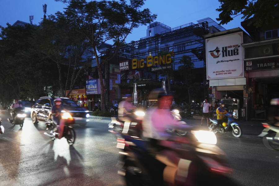 Drivers and motorcyclists move through a street during a blackout in Hanoi, Vietnam, on June 8, 2023. Vietnam has released a long-anticipated energy plan meant to take the country through the next decade and help meet soaring demand while reducing carbon emissions.