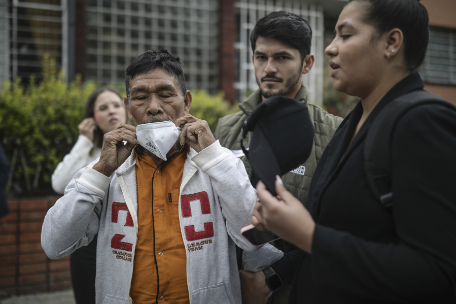 Narciso Mucutuy, the grandfather of the 4 rescued Indigenous children, puts on his mask after speaking to the media from the entrance of the military hospital where the children who survived an Amazon plane crash that killed three adults and then braved the jungle for 40 days before being found alive, are receiving medical attention, in Bogota, Colombia, Sunday, June 11, 2023.