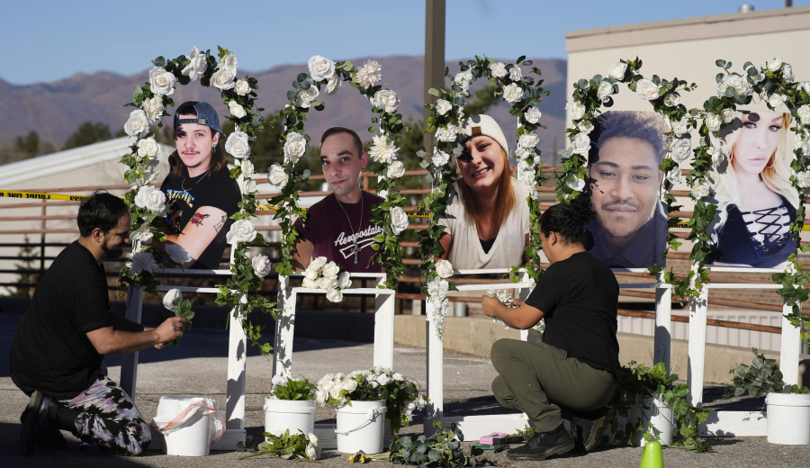 FILE - Noah Reich, left, and David Maldonado, the Los Angeles co-founders of Classroom of Compassion, set up a memorial near Club Q in Colorado Springs, Colo., on Nov. 22, 2022, with photographs of the five victims of a mass shooting at the gay nightclub.