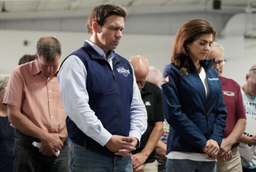 FILE - Republican presidential candidate Florida Gov. Ron DeSantis and his wife, Casey, bow their heads during a prayer at a campaign event, Wednesday, May 31, 2023, in Cedar Rapids, Iowa.