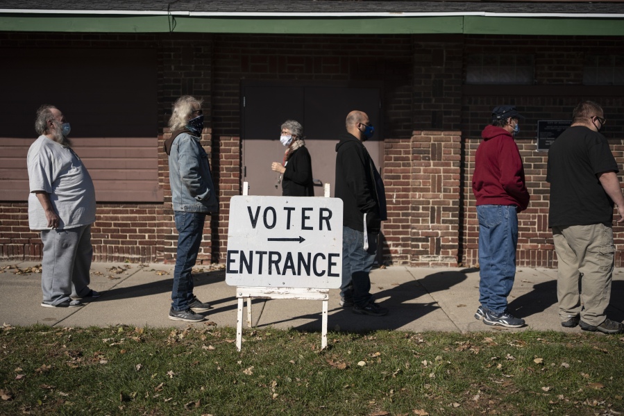 FILE - In this Nov. 3, 2020 file photo, voters wait in line outside a polling center on Election Day, in Kenosha, Wis. Wisconsin's top elections official is nearing the end of her term, and uncertainty looms over who will hold the position through the 2024 presidential election. Meagan Wolfe is the current, nonpartisan administrator of the Wisconsin Elections Commission. Republicans who control the state Legislature could have a chance to ouster her and pick someone new to oversee elections in the critical battleground state.