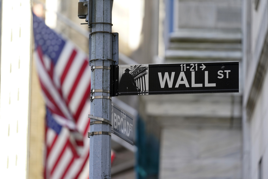 FILE - Flags adorn the facade of the New York Stock Exchange, Wednesday, June 16, 2021.  Wall Street is retreating a bit more as a five-week rally loses momentum.