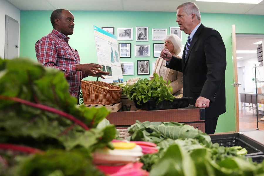 Tom Vilsack, U.S. Secretary of Agriculture, right, talks with farmer Sylvain Bukasa, of Dunbarton, N.H., at Fresh Start Food Hub & Market, Thursday, June 15, 2023, in Manchester, N.H. The U.S. Department of Agriculture is seeding agricultural producers and food businesses with millions of dollars in investments designed to improve markets, create and strengthen jobs, fight rising food prices and improve nutrition, Secretary Tom Vilsack said Thursday.