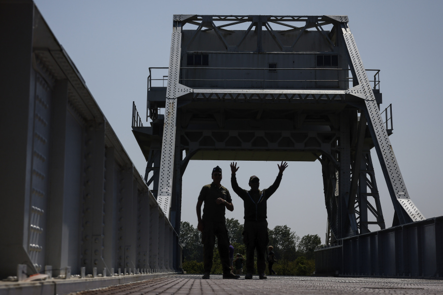 Servicemen walk on Pegasus Bridge, one of the first sites liberated by Allied forces from Nazi Germany, in Benouville, Normandy, Monday June 5, 2023. Dozens of World War II veterans have traveled to Normandy this week to mark the 79th anniversary of D-Day, the decisive but deadly assault that led to the liberation of France and Western Europe from Nazi control.