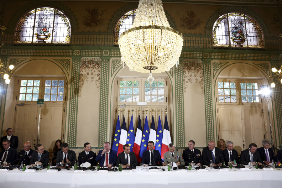 French President Emmanuel Macron, center, delivers his closing speech at the conference on European air and missile defense at the Invalides monument in Paris, Monday June 19, 2023. Defense ministers and other representatives of 20 European countries hold a conference in Paris on how to better defend Europe's airspace, a long-divisive issue that takes on new urgency because of Russia's war in Ukraine.