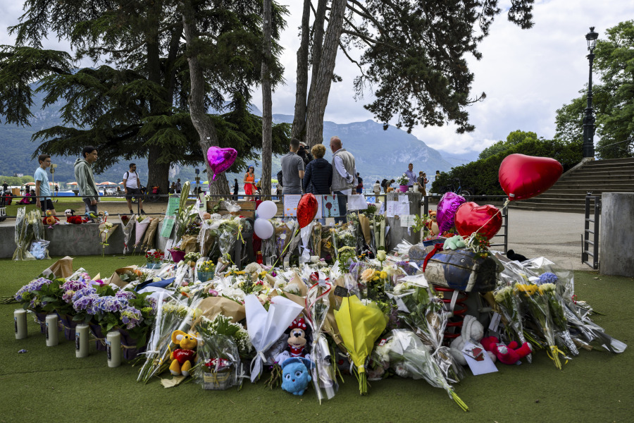 Flowers are laid down at a children's playground in Annecy, France, Saturday, June 10, 2023 following a knife attack on Thursday, June 8, 2023. French judges have handed preliminary charges of attempted murder to a man suspected of stabbing four young children and two adults in a French Alps park. The suspect is a 31-year-old Syrian refugee with permanent residency in Sweden.