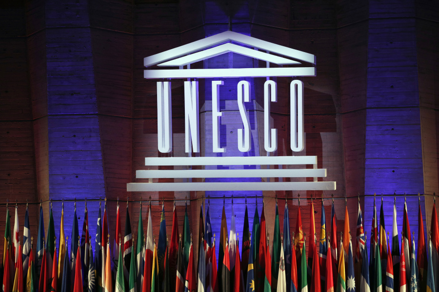 FILE - The logo of the United Nations Educational, Scientific and Cultural Organisation (UNESCO) is seen during the 39th session of the General Conference at the UNESCO headquarters in Paris, Saturday, Nov. 4, 2017. The United States is ready to rejoin the U.N. cultural and scientific agency UNESCO - and pay more than $600 million in back dues -- after a decade-long dispute sparked by the organization's move to include Palestine as a member.