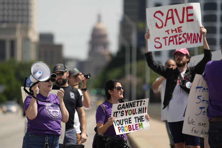 Editorial members of the Austin American-Statesman's Austin NewsGuild picket along the Congress Avenue bridge in Austin, Texas, Monday, June 5, 2023. The mostly one-day strike aims to protest the company's leadership and cost-cutting measures imposed since its 2019 merger with GateHouse Media.