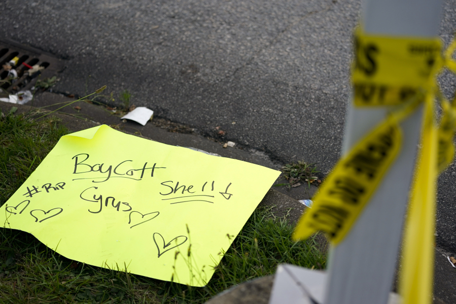 A sign lies on the ground across from the shuttered Xpress Mart Shell station in Columbia, S.C., Friday, June 2, 2023. Rick Chow, owner of the station, is accused of killing Carmack-Belton on Sunday night after chasing down the teenager, who he wrongly suspected of stealing four water bottles.