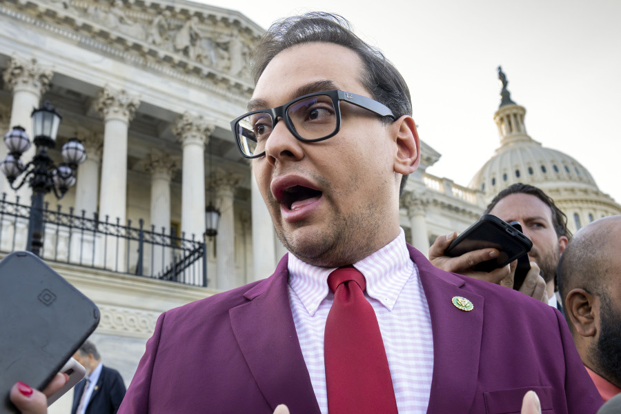 FILE - Rep. George Santos, R-N.Y., speaks to reporters outside the Capitol, in Washington, May 17, 2023. Santos, 34, has spent weeks fighting efforts by news outlets to unseal the names of the two people who co-signed the $500,000 bond, which enabled his pretrial release as he awaits federal charges of fraud, money laundering and theft of public funds. (AP Photo/J.