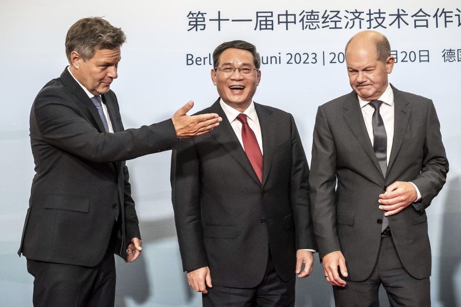 German Federal Minister for Economic Affairs and Climate Protection Robert Habeck, left, Chinese Premier Li Qiang, center, and German Chancellor Olaf Scholz arrive at the German-Chinese Forum for Economic and Technological Cooperation as part of the German-Chinese government consultations, in Berlin, Germany, June 20, 2023.