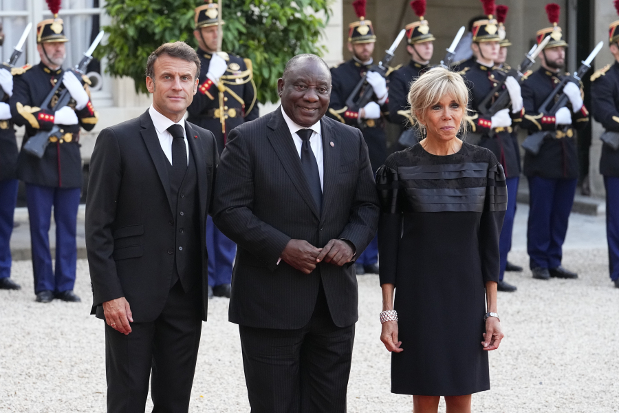 French President Emmanuel Macron and his wife Brigitte Macron welcome Cyril Ramaphosa, centre, President of South Africa centre, before dinner at the the Elysee Palace in Paris, Thursday, June 22, 2023. World leaders, heads of international organizations and activists are gathering in Paris for a two-day summit aimed at seeking better responses to tackle poverty and climate change issues by reshaping the global financial system.
