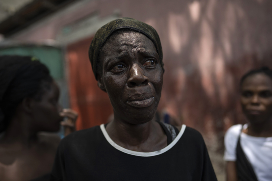 Dieu Frisdeline, who has sought refuge in Jean-Kere Almicar's front yard, cries as she tells how she was raped by gang members, in Port-au-Prince, Haiti, Sunday, June 4, 2023. Nearly 200 people who once lived in the Cite Soleil slum near Almicar's house are now camped out in his front yard and nearby areas. They are among the nearly 165,000 Haitians who have fled their homes amid a surge in gang violence.