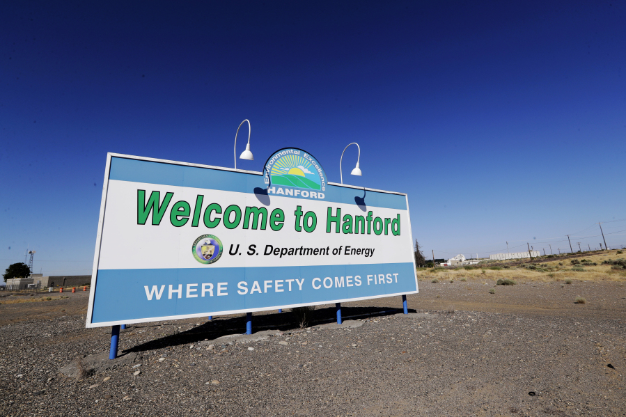 FILE - A sign at the Hanford Nuclear Reservation is posted near Richland, Wash., on Aug. 14, 2019. Three tribes have devoted decades to returning their ancestral lands in Washington to the days before they became the most radioactively contaminated site in the nation's nuclear weapons complex.  But the Yakama Nation, Confederated Tribes of the Umatilla Indian Reservation and Nez Perce Tribe have been left out of negotiations on a major decision affecting the future cleanup of millions of gallons of radioactive waste stored in underground tanks on the reservation.