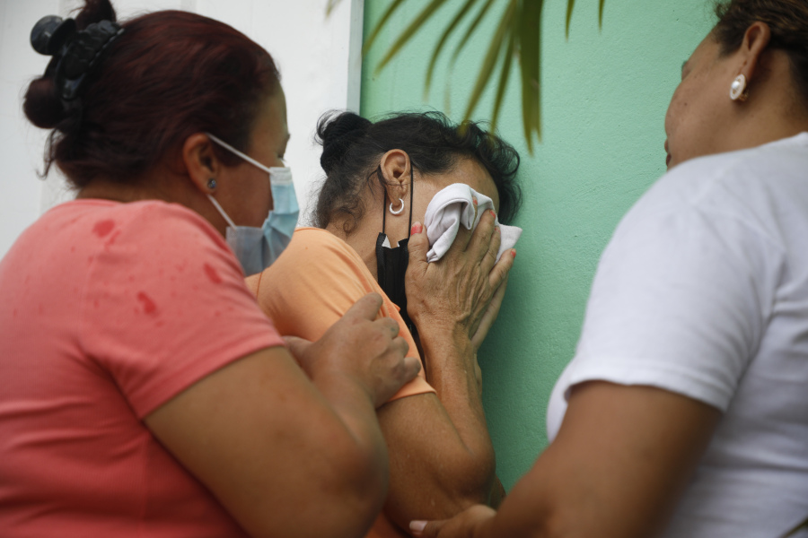 Relatives of inmates wait in distress outside the entrance to the women's prison in Tamara, on the outskirts of Tegucigalpa, Honduras, Tuesday, June 20, 2023. A riot at the women's prison has left at least 41 inmates dead, most of them burned to death, a Honduran police official said.
