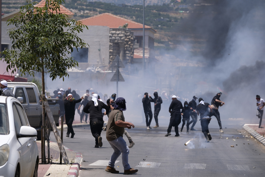 Druze protesters clash with Israeli police who fired tear gas as thousands took part in the demonstrations against the construction of massive wind turbines, in the Golan Heights, Wednesday, June 21, 2023. Police fired tear gas, sponge-tipped bullets and a water cannon during the mass demonstrations by Druze Arabs -- a rare burst of violence in the normally quiet area.