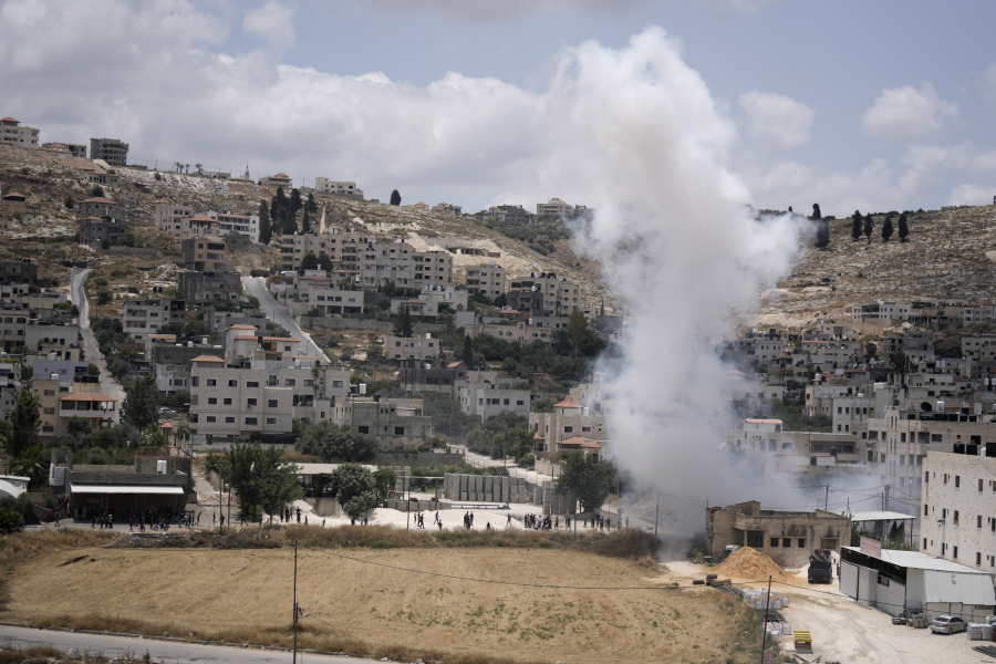 Smoke rises during fighting between Israeli forces and Palestinian militants in the West Bank city of Jenin, Monday, June 19, 2023. Israeli helicopter gunships struck targets in the West Bank, during a fierce gunbattle in which Palestinian militants detonated a roadside bomb next to an Israeli military vehicle. At least three Palestinians, including a 15-year-old boy, were killed. Twenty-nine Palestinians were wounded and the Israeli military said seven members of the border police and the army were hurt. They said troops came under fire during an arrest raid in Jenin and shot back at gunmen.