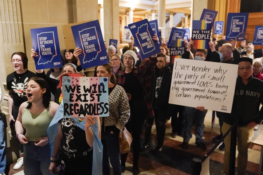FILE - Protesters stand outside of the Senate chamber at the Indiana Statehouse on Feb. 22, 2023, in Indianapolis. The Human Rights Campaign declared a state of emergency for LGBTQ+ people in the U.S. on Tuesday, June 6 and a released a guidebook summarizing what it calls discriminatory laws in each state, along with "know your rights" information and health and safety resources.