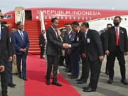In this photo released by Malaysia's Department of Information, Indonesian president Joko Widodo, center, is greeted by representatives from Malaysian government upon the arrival at KLIA international airport in Sepang, Malaysia Wednesday, June 7, 2023.