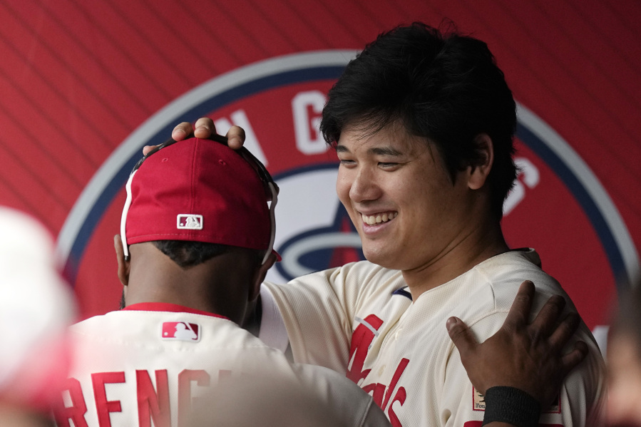 Los Angeles Angels' Shohei Ohtani, right, pats Luis Rengifo on the head prior to a baseball game against the Seattle Mariners Sunday, June 11, 2023, in Anaheim, Calif. (AP Photo/Mark J.