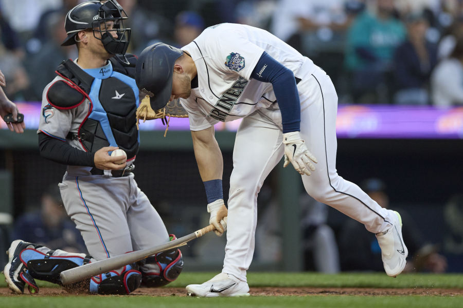 Seattle Mariners' Jarred Kelenic cracks his bat as he reacts to striking out against the Miami Marlins during the seventh inning of a baseball game Wednesday, June 14, 2023, in Seattle.
