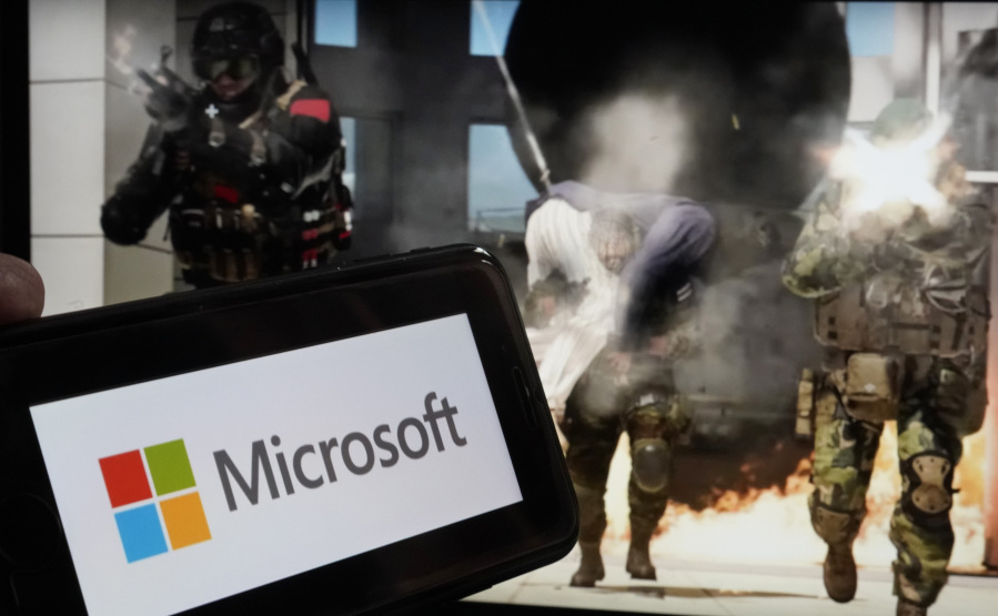 The logo for Microsoft, and a scene from Activision "Call of Duty - Modern Warfare," are shown in this photo, in New York, Wednesday, June 21, 2023. Microsoft on Thursday will try to gain clearance to complete a $69 billion takeover of video game maker Activision Blizzard in a legal showdown with U.S. regulators that will reshape a pastime that's bigger than the movie and music industries combined.