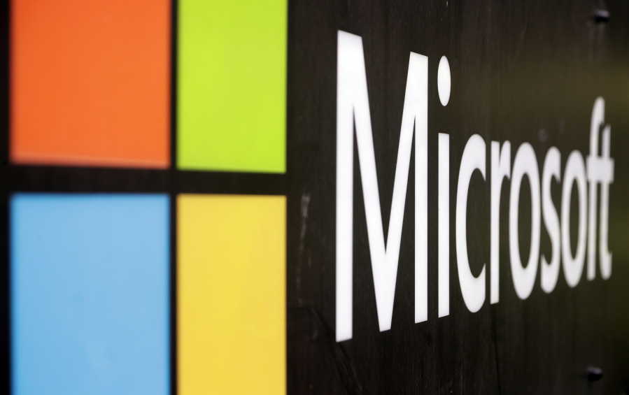 FILE - The Microsoft company logo is displayed at their offices in Sydney, Australia, on Feb. 3, 2021. Microsoft says the early June 2023 disruptions to its Microsoft's flagship office suite -- including the Outlook email and OneDrive file-sharing apps -- were denial-of-service attacks by a shadowy new hacktivist group.