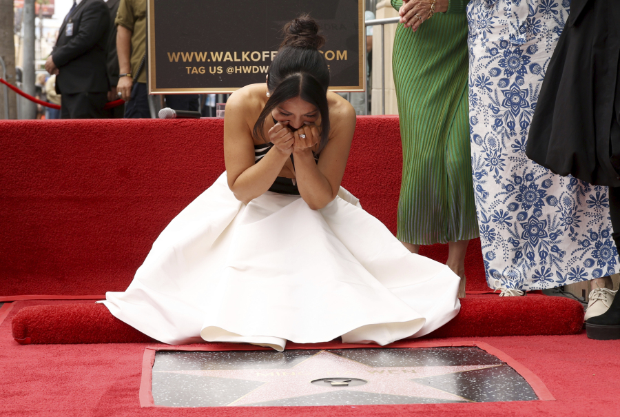 Ming-Na Wen, known for her roles in "The Joy Luck Club" and "Mulan," reacts upon seeing her new star on the Hollywood Walk of Fame during a ceremony on Tuesday, May 30, 2023, in Los Angeles.