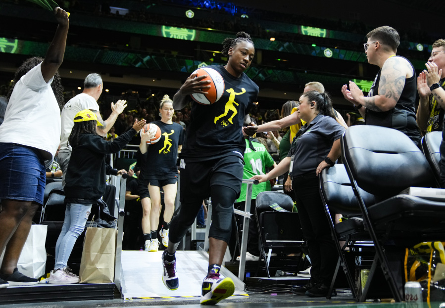 Seattle Storm guard Jewell Loyd runs out for warm ups wearing a Sue Bird shirt before a WNBA basketball game against the Washington Mystics, Sunday, June 11, 2023, in Seattle. Bird's jersey number was retired in a postgame ceremony.