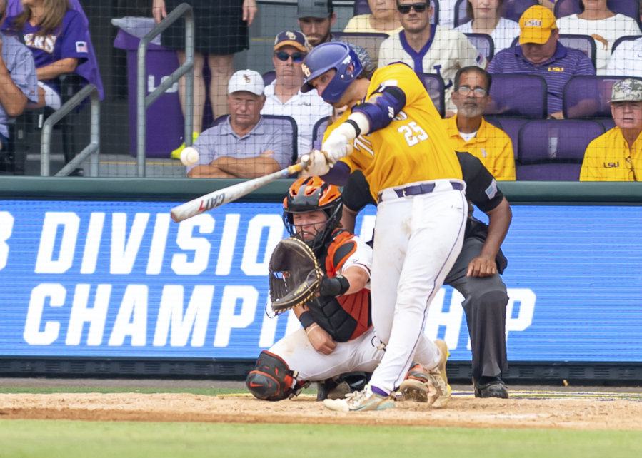 LSU's Hatden Travinski (25) swings for a home run against Oregon State during an NCAA college baseball tournament regional championship game in Baton Rouge, La., Monday, June 5, 2023.