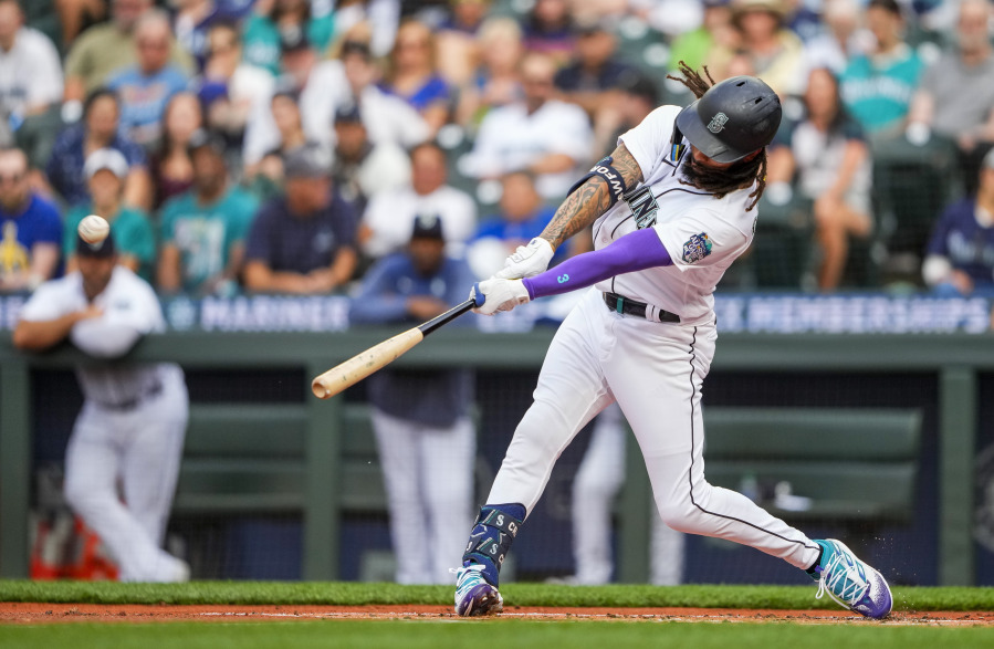 Seattle Mariners' J.P. Crawford hits a solo home run against Washington Nationals starting pitcher Trevor Williams during the first inning of a baseball game Monday, June 26, 2023, in Seattle.