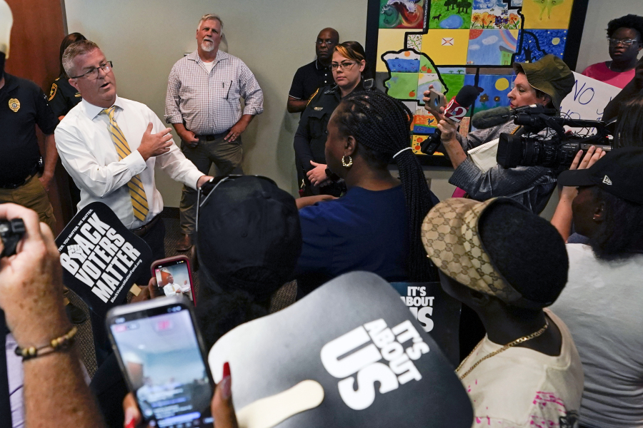 State Attorney William Gladson, left, speaks to a group of protesters and the media outside his office at the Marion County Courthouse, Tuesday, June 6, 2023, in Ocala, as protesters demand the arrest of a woman who shot and killed Ajike Owens, a 35-year-old mother of four, last Friday night, June 2. Authorities came under intense pressure Tuesday to bring charges against a white woman who killed Owens, a Black neighbor, on her front doorstep, as they navigated Florida's divisive stand your ground law that provides considerable leeway to the suspect in making a claim of self defense.