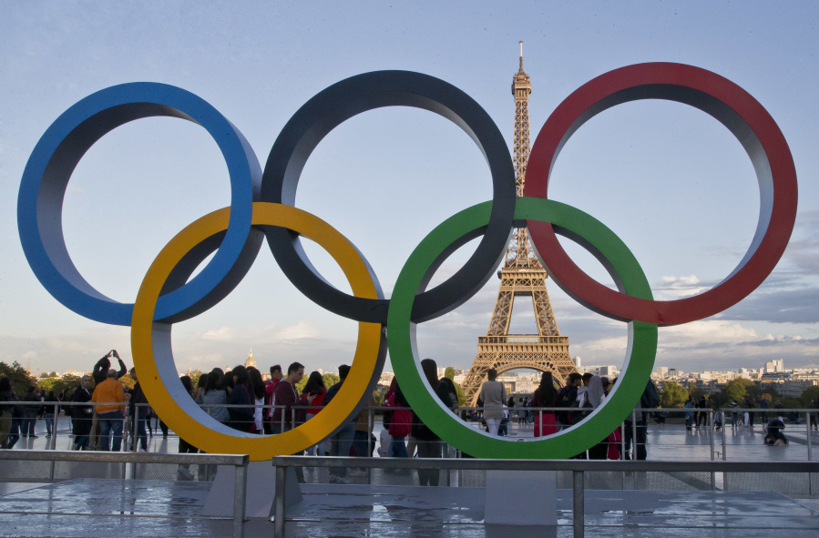 FILE - The Olympic rings are set up in Paris, France, Thursday, Sept. 14, 2017 at Trocadero plaza  that overlooks the Eiffel Tower, a day after the official announcement that the 2024 Summer Olympic Games will be in the French capital. An IOC inspection team has given a resounding thumbs-up to Paris' preparations for the 2024 Olympic Games. The IOC said Wednesday that Paris organizers are where they should be in their planning with 415 days to go before the opening ceremony.