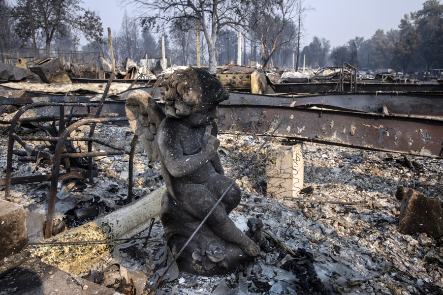 FILE - A charred statue sits among the destruction at Coleman Creek Estates mobile home park in Phoenix, Ore., Thursday, Sept. 10, 2020. A jury verdict that found power company PacifiCorp liable for devastating wildfires in Oregon in 2020 is highlighting the legal and financial risks utilities face if they fail to take proper precautions for climate change.