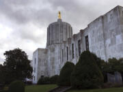 FILE - Clouds hover over the Oregon Capitol, Jan. 11, 2018, in Salem, Ore. Oregon Senate Democrats plan to start fining their absent colleagues amid a month-long Republican walkout, a move they hope will pressure boycotting lawmakers to return to the chamber as hundreds of bills languish amid the partisan stalemate. In a procedural move Thursday, June 1, 2023, Democrats voted to fine senators $325 every time their absence denies the chamber the two-thirds quorum it needs to conduct business.