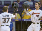 Oregon State outfielder Micah McDowell (12) celebrates a home run with Oregon State infielder Travis Bazzana (37) during an NCAA baseball game against Sam Houston on Friday, June 2, 2023, in Baton Rouge, La.