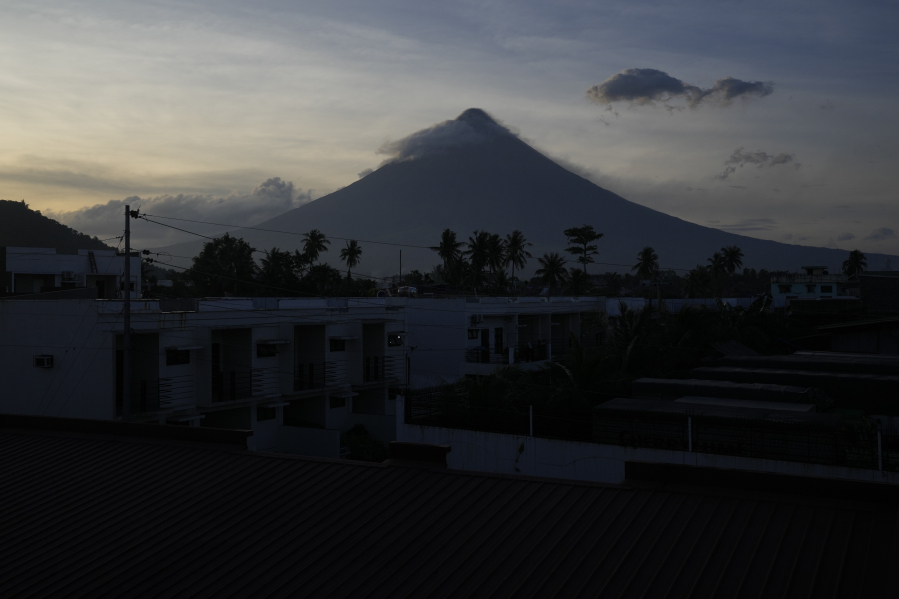 Mayon Volcano as seen from Legaspi, Albay province, northeastern Philippines., Monday, June 12, 2023. The Philippines' most active volcano was gently spewing lava down its slopes Monday, alerting tens of thousands of people they may have to quickly flee a violent and life-threatening explosion.