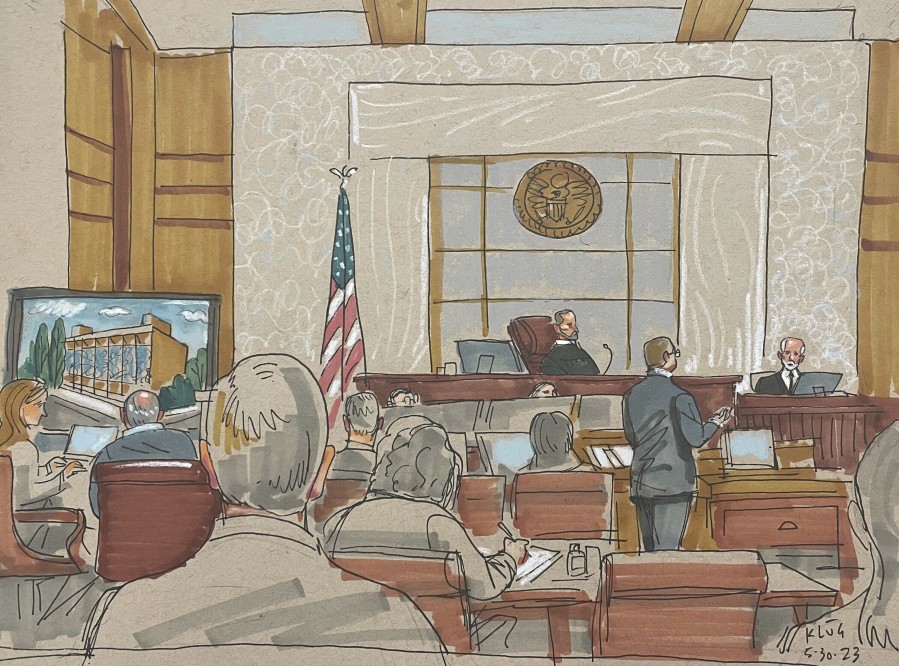 In this courtroom sketch, prosecuting attorney Eric G. Olshan questions witness Rabbi Jeffrey Myers of the Tree of Life Congregation, in the federal trial for 2018 synagogue massacre suspect Robert Bowers, on Tuesday, May 30, 2023, in Pittsburgh. Bowers could face the death penalty if convicted of some of the 63 counts he faces in the shootings, which claimed the lives of worshippers from three congregations who were sharing the building, Dor Hadash, New Light and Tree of Life.