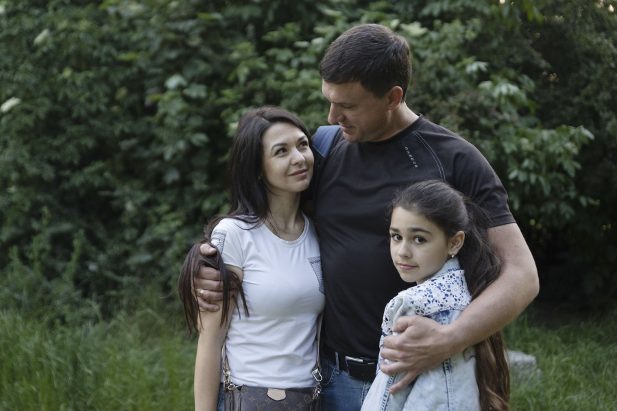 Milana Minenko, a 9-year-old child from Ukraine, right, enjoys a tender moment with her parents Oksana and Oleksandr Minenko, in a park in Warsaw, Poland, Wednesday June 7, 2023. Russian forces have destroyed 262 educational institutions and damaged another 3,019 in their invasion of Ukraine, according to government figures. For those who've fled to other countries, schooling is suffering in unprecedented ways, according to families, educators, experts and advocates. The effects of war and relocation combined with the challenges of studying in a new country are compounding educational setbacks for young refugees.