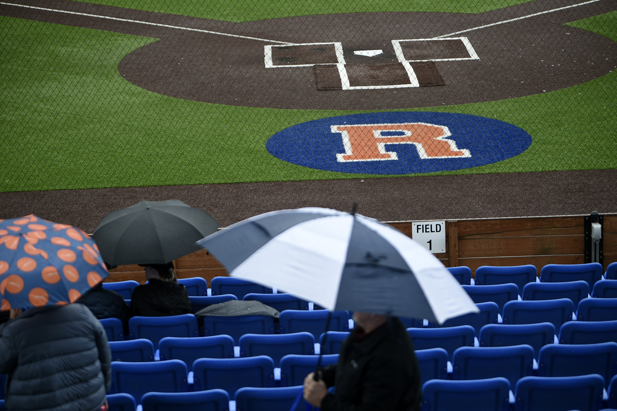 Fans use umbrellas to protect themselves from the rain, which led to the Ridgefield Raptors’ game vs. the Cowlitz Black Bears to be rained out on Sunday, June 18.