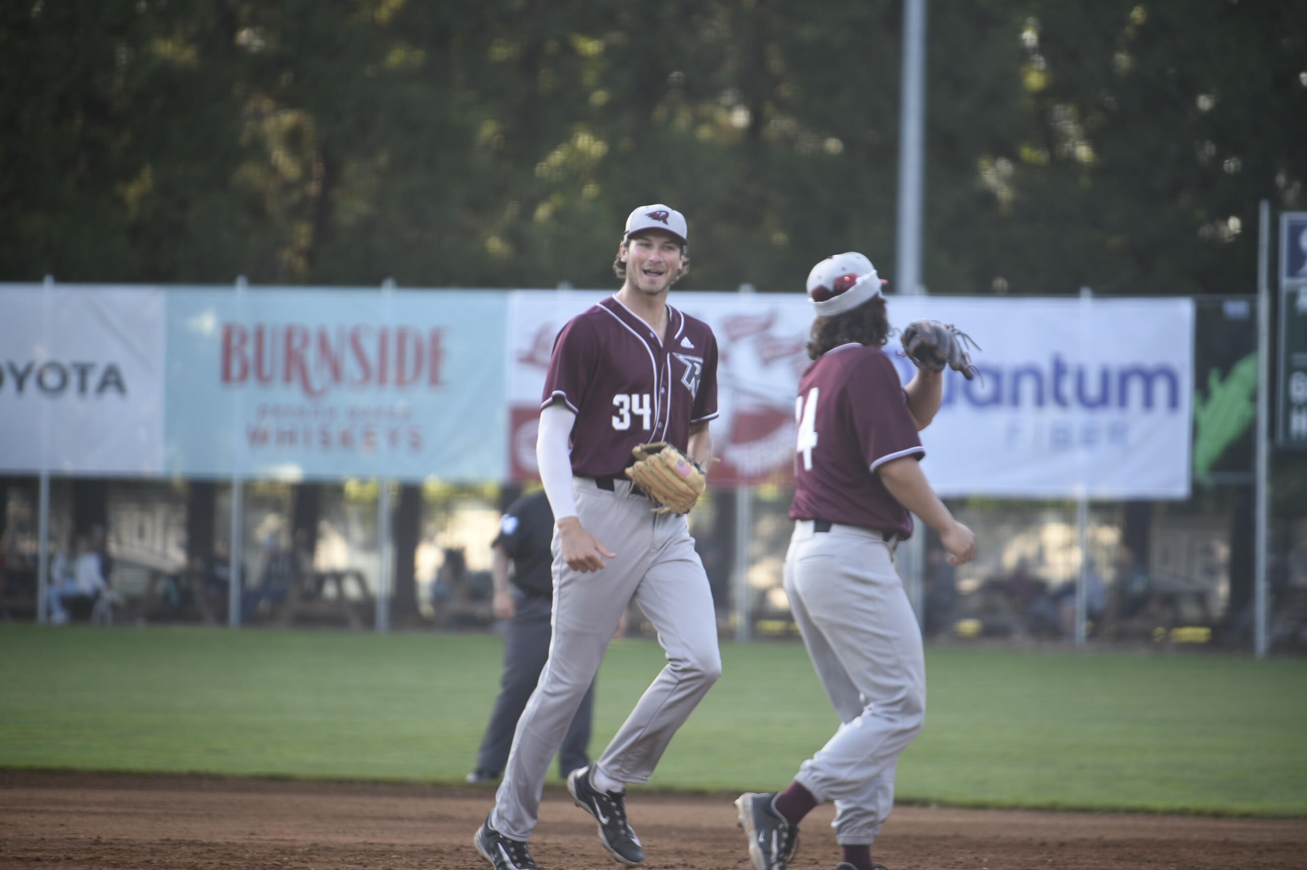 Ridgefield Raptors outfielder Tristan Gomes, left, is greeted by outfielder Jake Tsukada after Gomes made a leaping catch in left field to end the third inning against the Portland Pickles at Walker Stadium in Portland on Wednesday, June 14, 2023.
