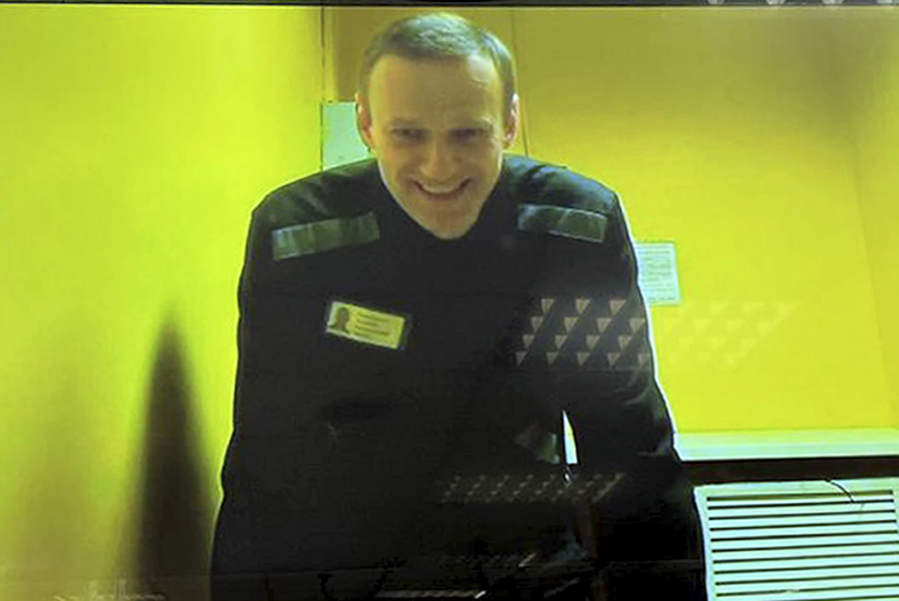 In this handout photo released by Moscow City Court Press Service, Russian opposition leader Alexei Navalny is seen on a TV screen, as he appears in a video link provided by the Russian Federal Penitentiary Service in a courtroom at Moscow City Court in Moscow, Russia, Wednesday, May 31, 2023. Imprisoned Russian opposition leader Alexei Navalny said in April that he was facing new extremism and terrorism charges that could keep him behind bars for life.
