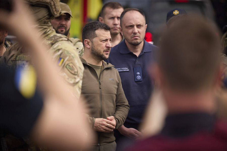 In this photo provided by the Ukrainian Presidential Press Office, Ukrainian President Volodymyr Zelenskyy visits the flooding hit areas in Kherson, Ukraine, Thursday, June 8, 2023.