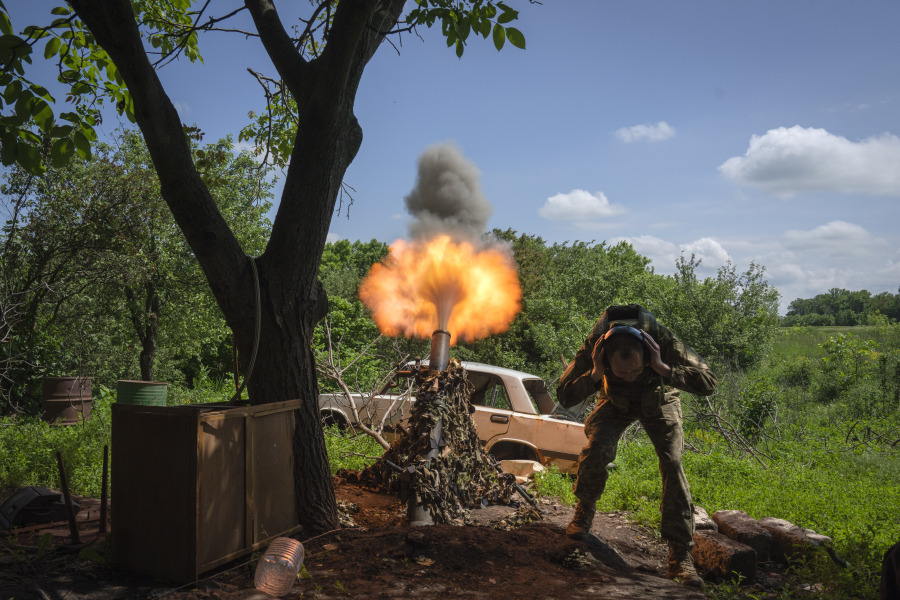 A Ukrainian soldier fires a mortar at Russian positions on the frontline near Bakhmut, Donetsk region, Ukraine, Monday, May 29, 2023.